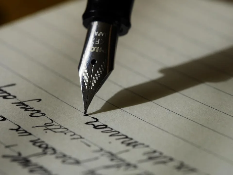 Fountain pen resting on a handwritten page